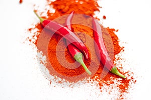 fresh red hot pepper and powder on a white background