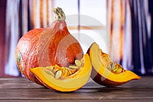 Fresh red kuri pumpkin hokkaido with curtains