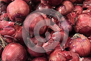 Fresh red onion piled on the market. Food backgroumd. Harvest