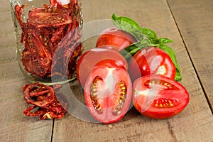 Fresh red paste tomatoes with basil and jar