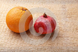 Fresh red pomegranate and grapefruit On a wooden background