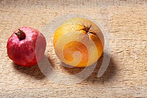 Fresh red pomegranate and grapefruit On a wooden background