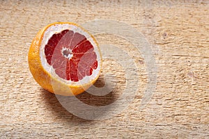 Fresh red pomegranate and grapefruit On a wooden background
