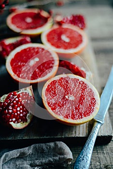 Fresh red pomegranate and grapefruit On a wooden background. Pom