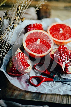 Fresh red pomegranate and grapefruit On a wooden background. Pom