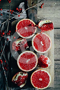 Fresh red pomegranate and grapefruit On a wooden background. Pom