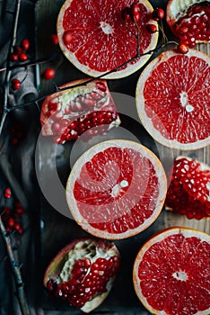 Fresh red pomegranate and grapefruit On a wooden background. Pom