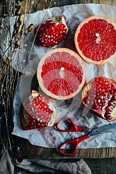 Fresh red pomegranate and grapefruit On a wooden background. Pom