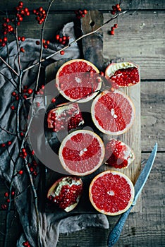 Fresh red pomegranate and grapefruit On a wooden background. Pom