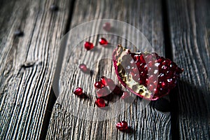 Fresh red pomegranate and grapefruit On a wooden background. Pomegranate in plate on wood background.