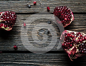 Fresh red pomegranate and grapefruit On a wooden background. Pomegranate in plate on wood background.