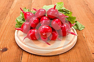 Fresh red radish on wooden cutting board