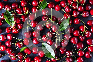 Fresh red ripe cherries on dark grey table