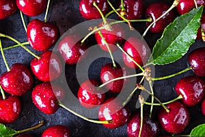 Fresh red ripe cherries on dark grey table