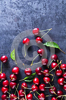 Fresh red ripe cherries on dark grey table