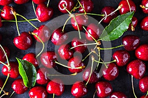 Fresh red ripe cherries on dark grey table