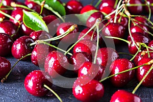 Fresh red ripe cherries on dark grey table