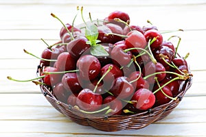 Fresh red ripe cherries in wicker basket