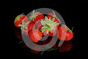 Fresh red ripe strawberries on a black background