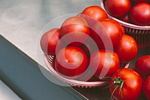 Fresh red ripe tomatoes in a bowl on street market or greengrocery