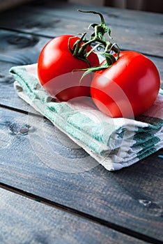 Fresh red ripe tomatoes on a branch