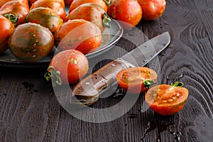 Fresh red ripe tomatoes on rustic board