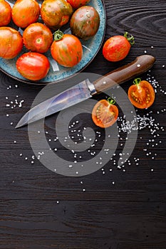 Fresh red ripe tomatoes on rustic board