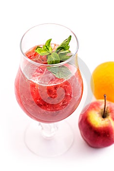 Fresh red smoothie with mint leaf in glass isolated on white background, strawberry, red currant, orange and apple drink, product