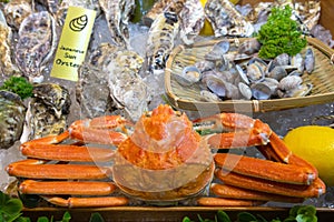 fresh red snow crab, japanese sun oysters and other seafood display on ice in the stall at tsukiji fish market in japan. Tsukiji