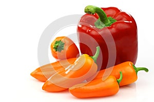 A fresh red and some orange peppers