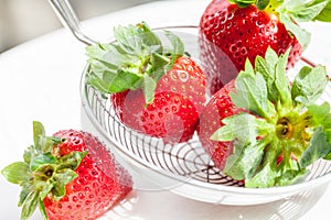 Fresh red strawberries on a colander