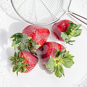 Fresh red strawberries on a colander