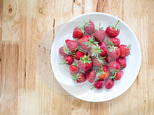 Fresh red strawberries in plate put on the table
