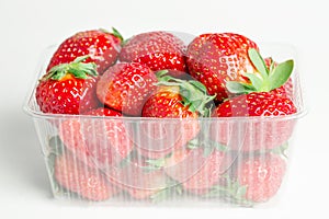 Fresh red strawberries prepacked in a plastic transparent container