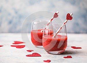 Fresh red strawberry margarita  or daiquiri cocktail with hearts over gray background, valentine day concepts