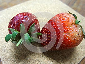 Fresh red strawberry on wooden plate
