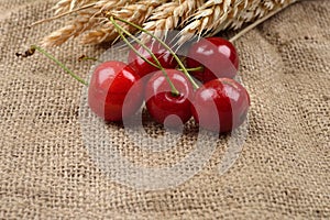 Fresh red and tasty cherries on jude background, with bunch of w