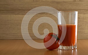 Fresh red tomato and a glass of tomato juice