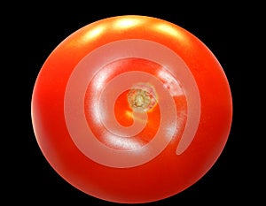 Fresh red tomato isolated on a black background