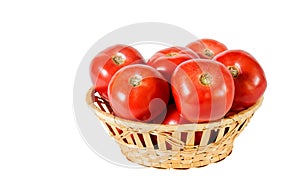 Fresh red tomatoes in basket isolated on white. Selective focus