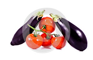 Fresh red tomatoes on bunch and eggplants