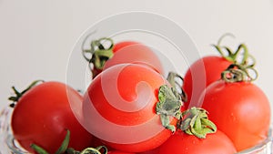 Fresh  red tomatoes cherry in a bowl isolated on white