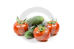 Fresh red tomatoes and cucumbers  on white background