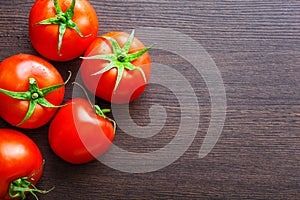 Fresh red tomatoes on table