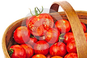 Fresh red tomatoes in wicker basket