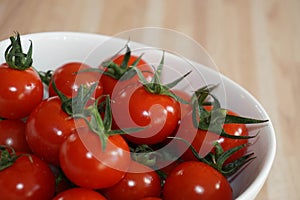 Fresh red tomatos in a white bowl