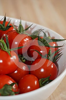 Fresh red tomatos in a white bowl