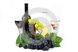 Fresh Red and White Grapes with Green Leaves, Two Wine Glass Cups and Wine Bottles Filled with Red and White Wine Isolated