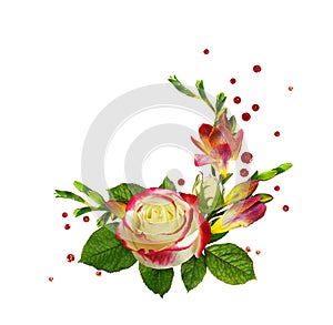Fresh red and yellow freesia flowers and rose with confetti in a corner floral arrangement isolated on white