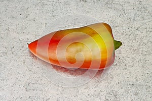 Fresh red and yellow whole pepper above view isolated with metal background